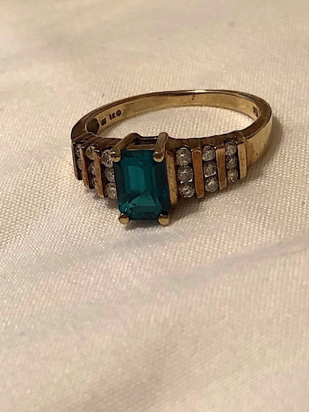 10k Gold Ring With Emerald And Surrounding Diamonds